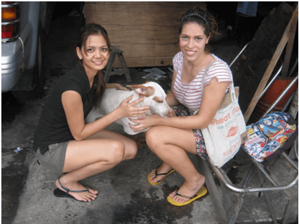 Esmee and fellow intern Charm pose with Christmas while volunteering for Pasay Pups.