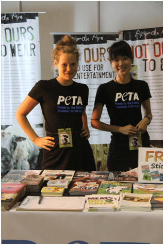 Olivia and fellow intern Fern work behind the information table at a Morrissey concert in Manila.